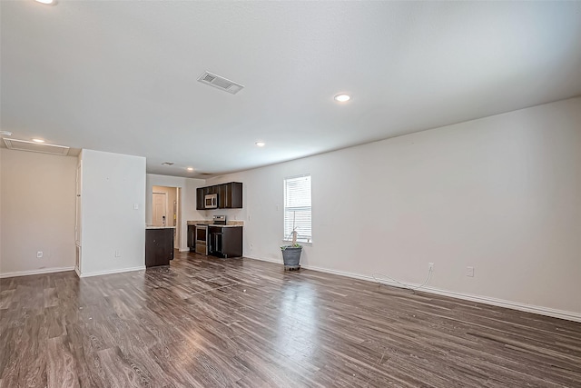 unfurnished living room featuring dark hardwood / wood-style flooring