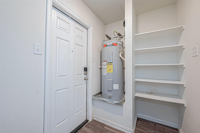 utility room featuring water heater