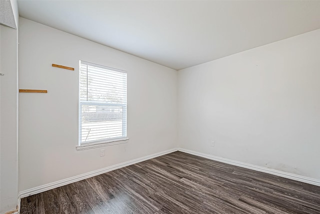 unfurnished room with dark hardwood / wood-style floors