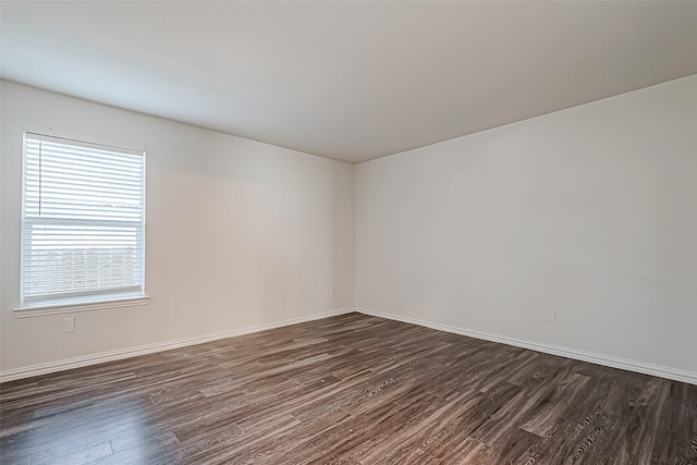 spare room featuring dark wood-type flooring