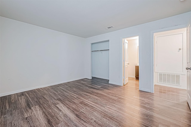 unfurnished bedroom featuring hardwood / wood-style flooring