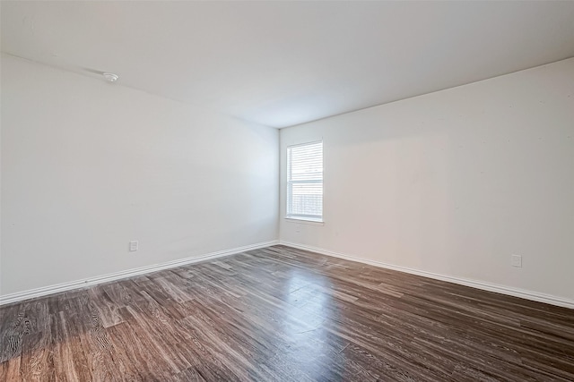 unfurnished room with dark hardwood / wood-style floors