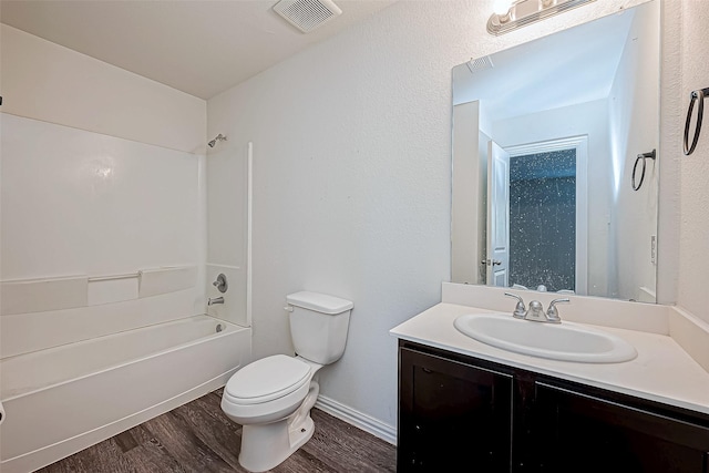 full bathroom with vanity, hardwood / wood-style flooring, toilet, and tub / shower combination