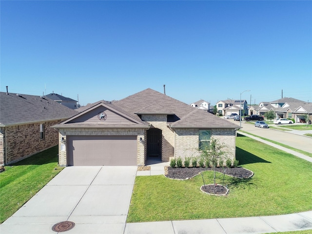 view of front of home with a front yard and a garage