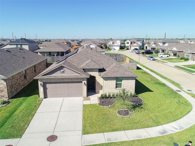 view of front of home featuring a garage and a front yard