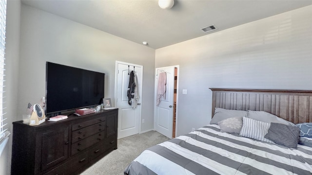 carpeted bedroom featuring vaulted ceiling and a closet