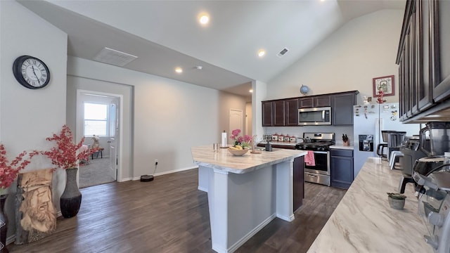 kitchen featuring a center island with sink, dark hardwood / wood-style flooring, dark brown cabinetry, and stainless steel appliances