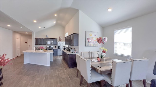 dining space with dark hardwood / wood-style flooring and vaulted ceiling