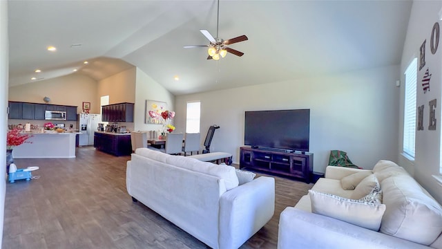 living room featuring ceiling fan, high vaulted ceiling, and dark wood-type flooring