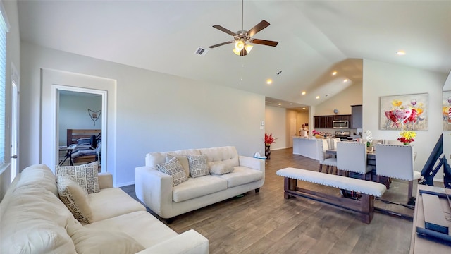 living room featuring ceiling fan, dark hardwood / wood-style flooring, and high vaulted ceiling