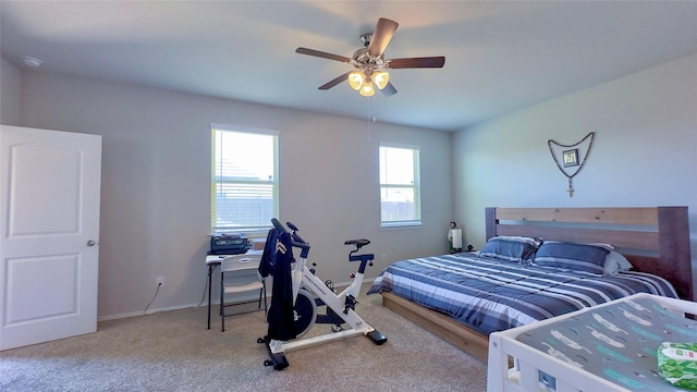 carpeted bedroom with ceiling fan and multiple windows