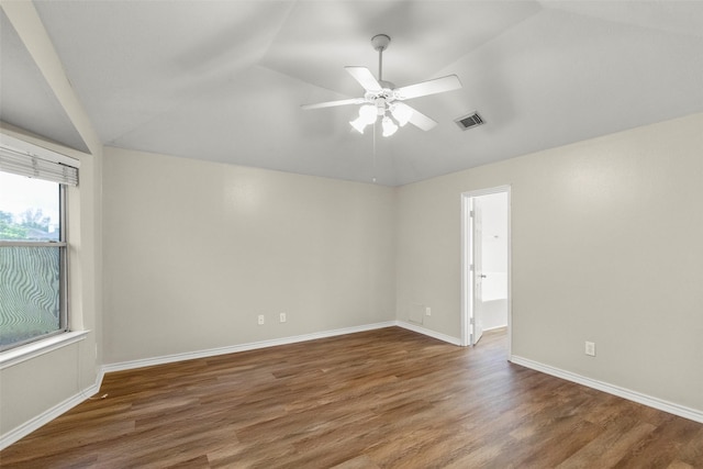 spare room with ceiling fan, dark hardwood / wood-style flooring, and vaulted ceiling