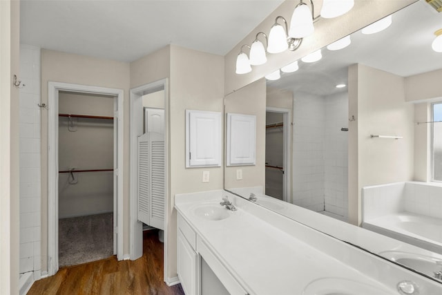 bathroom with a bathtub, vanity, and wood-type flooring