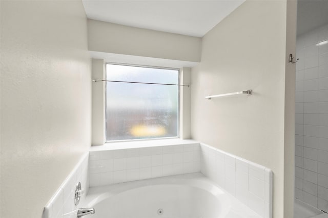 bathroom featuring a bathtub and a wealth of natural light