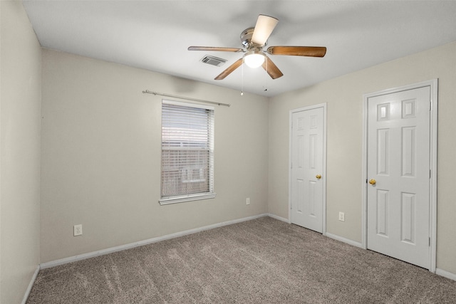 unfurnished bedroom featuring carpet and ceiling fan