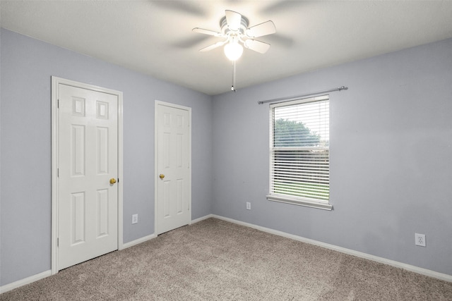 unfurnished bedroom with ceiling fan and light carpet