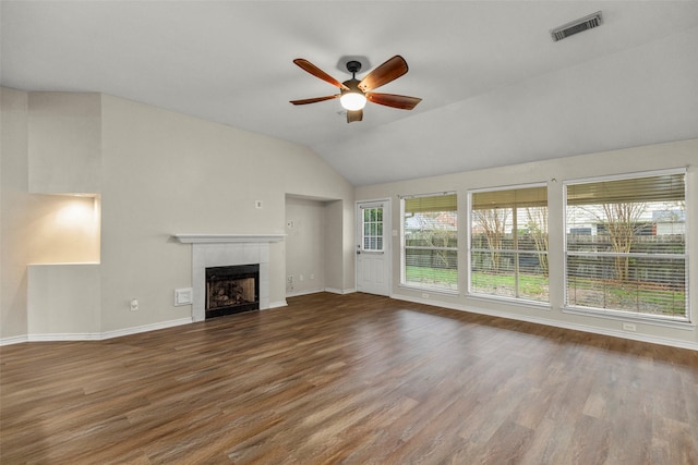 unfurnished living room with a tiled fireplace, ceiling fan, wood-type flooring, and vaulted ceiling