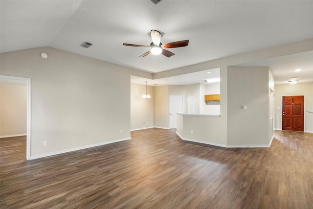 unfurnished living room featuring lofted ceiling, ceiling fan with notable chandelier, and dark wood-type flooring