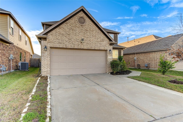 view of front of property featuring a front yard, a garage, and central air condition unit