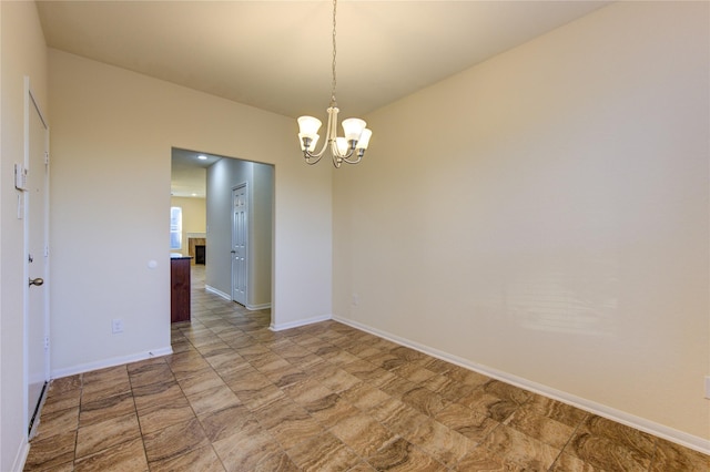 empty room featuring a notable chandelier