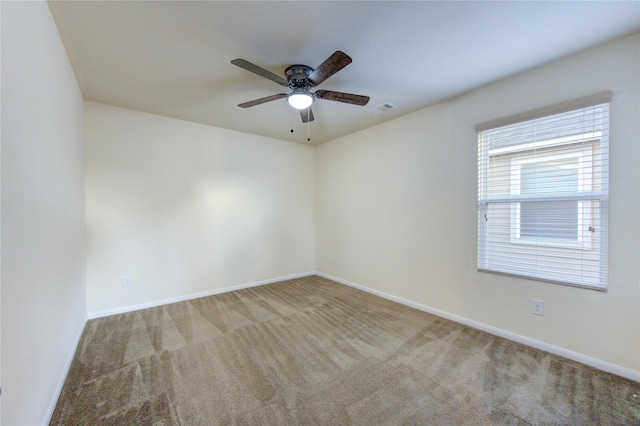 carpeted empty room featuring ceiling fan