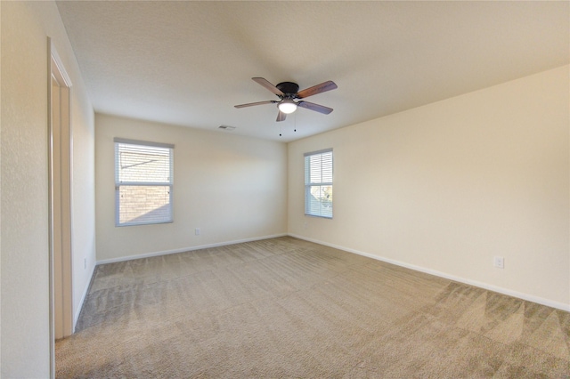 spare room featuring ceiling fan and light colored carpet