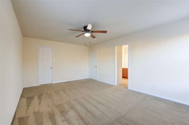 unfurnished room with ceiling fan and light colored carpet