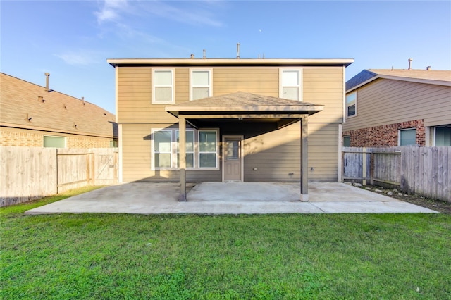 rear view of property with a lawn and a patio area