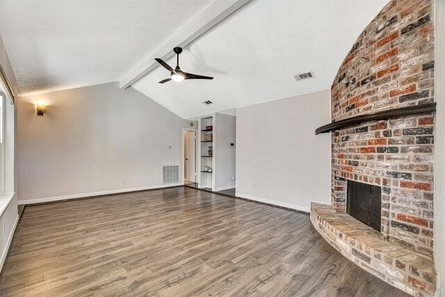 unfurnished living room featuring hardwood / wood-style floors, vaulted ceiling with beams, a brick fireplace, and ceiling fan