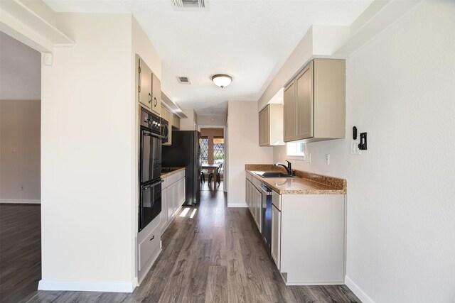 kitchen with sink, dark wood-type flooring, and appliances with stainless steel finishes