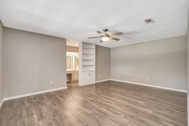 interior space featuring a textured ceiling, hardwood / wood-style flooring, and ceiling fan