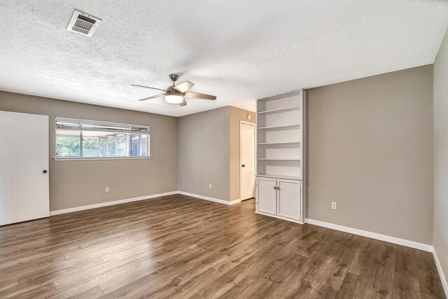 interior space with a textured ceiling, dark hardwood / wood-style flooring, and ceiling fan