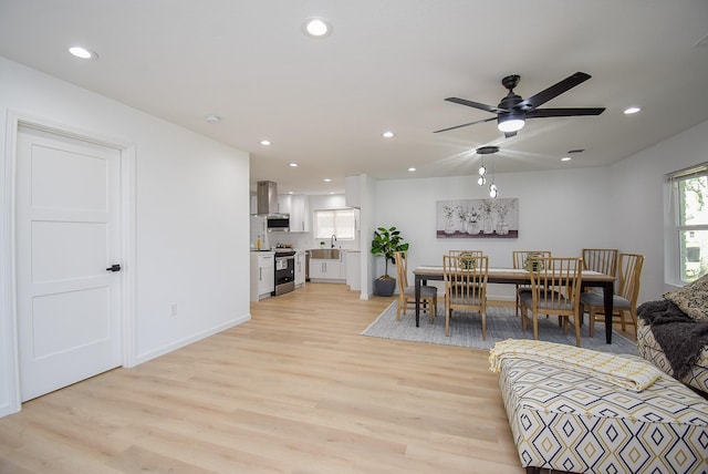 interior space featuring light wood-type flooring, ceiling fan, and sink