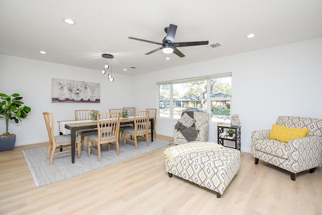 dining room with ceiling fan and light hardwood / wood-style floors