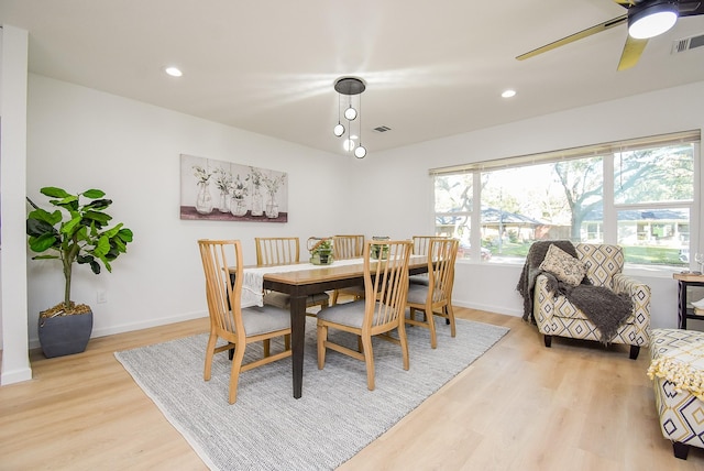 dining area with ceiling fan and light hardwood / wood-style flooring