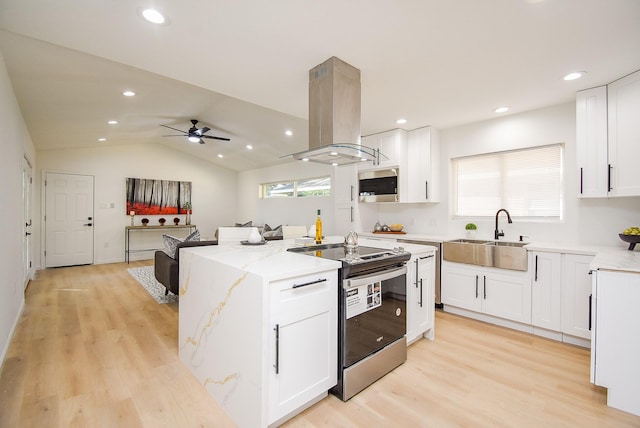 kitchen featuring island exhaust hood, stainless steel appliances, vaulted ceiling, sink, and white cabinets