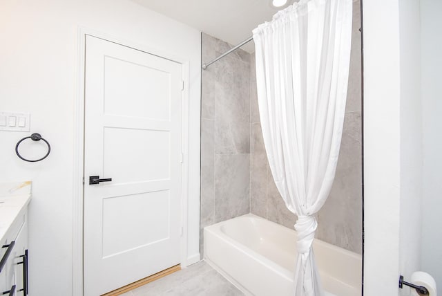 bathroom with tile patterned flooring, shower / bath combination with curtain, and vanity