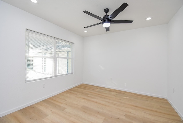 spare room featuring ceiling fan and light hardwood / wood-style floors