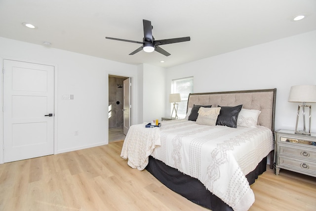 bedroom featuring ceiling fan, light hardwood / wood-style floors, and connected bathroom