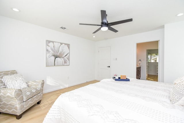 bedroom with ceiling fan, light hardwood / wood-style flooring, and ensuite bathroom