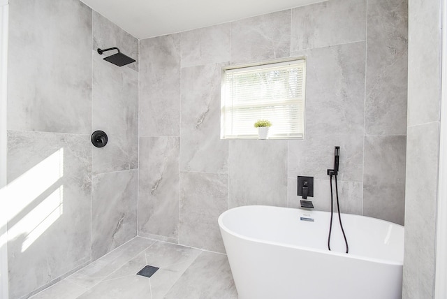 bathroom featuring plus walk in shower and tile walls