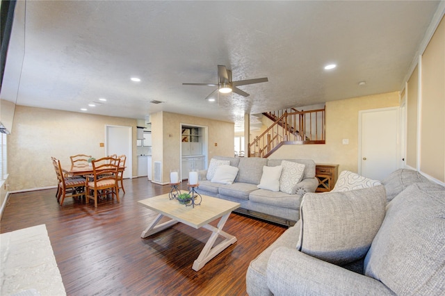 living room featuring dark hardwood / wood-style flooring and ceiling fan