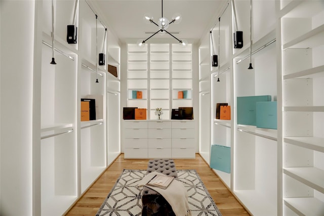 mudroom featuring light hardwood / wood-style flooring and a notable chandelier