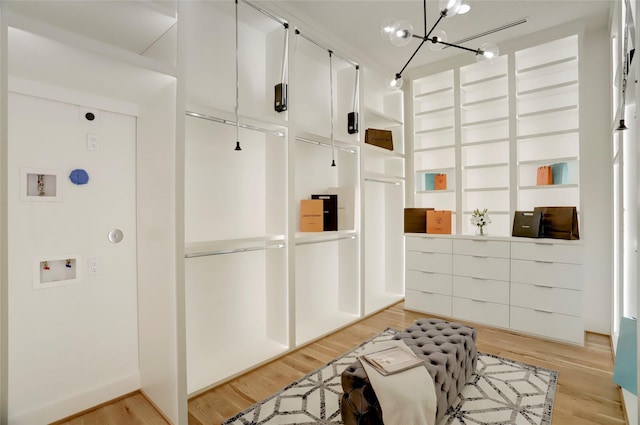 interior space with a notable chandelier and light wood-type flooring