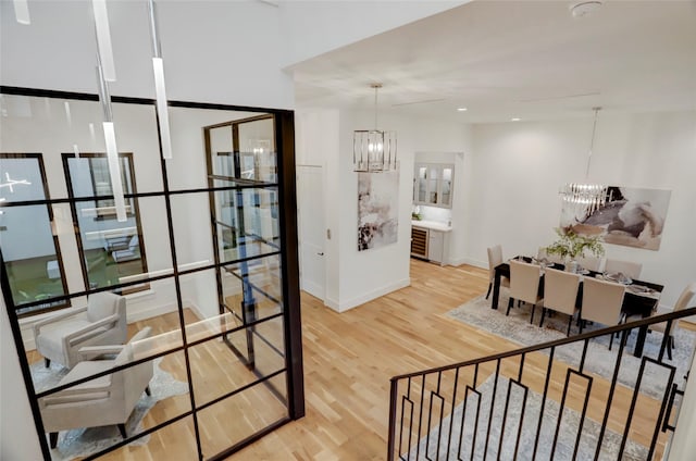 dining area with wood-type flooring and a notable chandelier