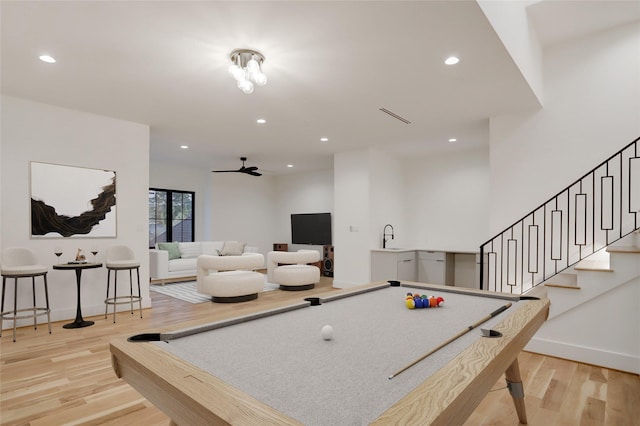 rec room featuring light hardwood / wood-style flooring, pool table, and sink