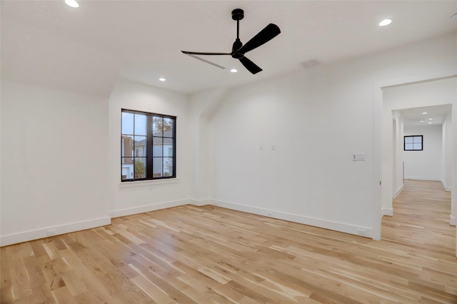 spare room featuring light hardwood / wood-style floors and ceiling fan