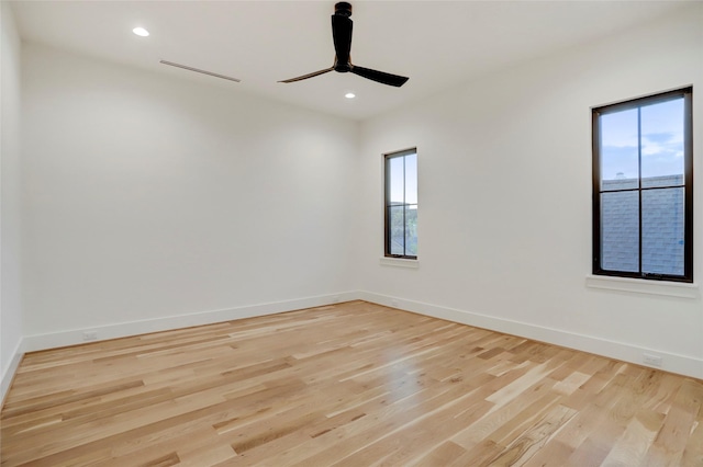 spare room featuring ceiling fan and light hardwood / wood-style flooring