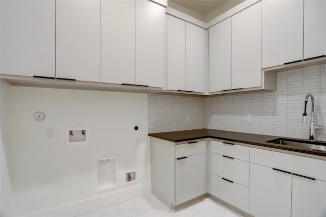 clothes washing area with gas dryer hookup, cabinets, sink, washer hookup, and hookup for an electric dryer