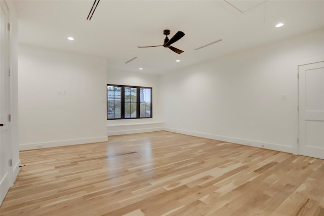 spare room featuring ceiling fan and light wood-type flooring